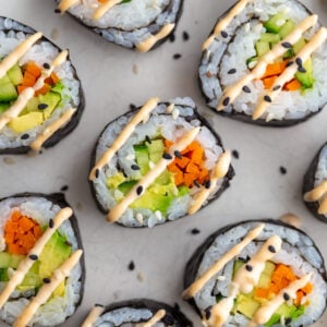 Cucumber rolls drizzled with spicy mayo.