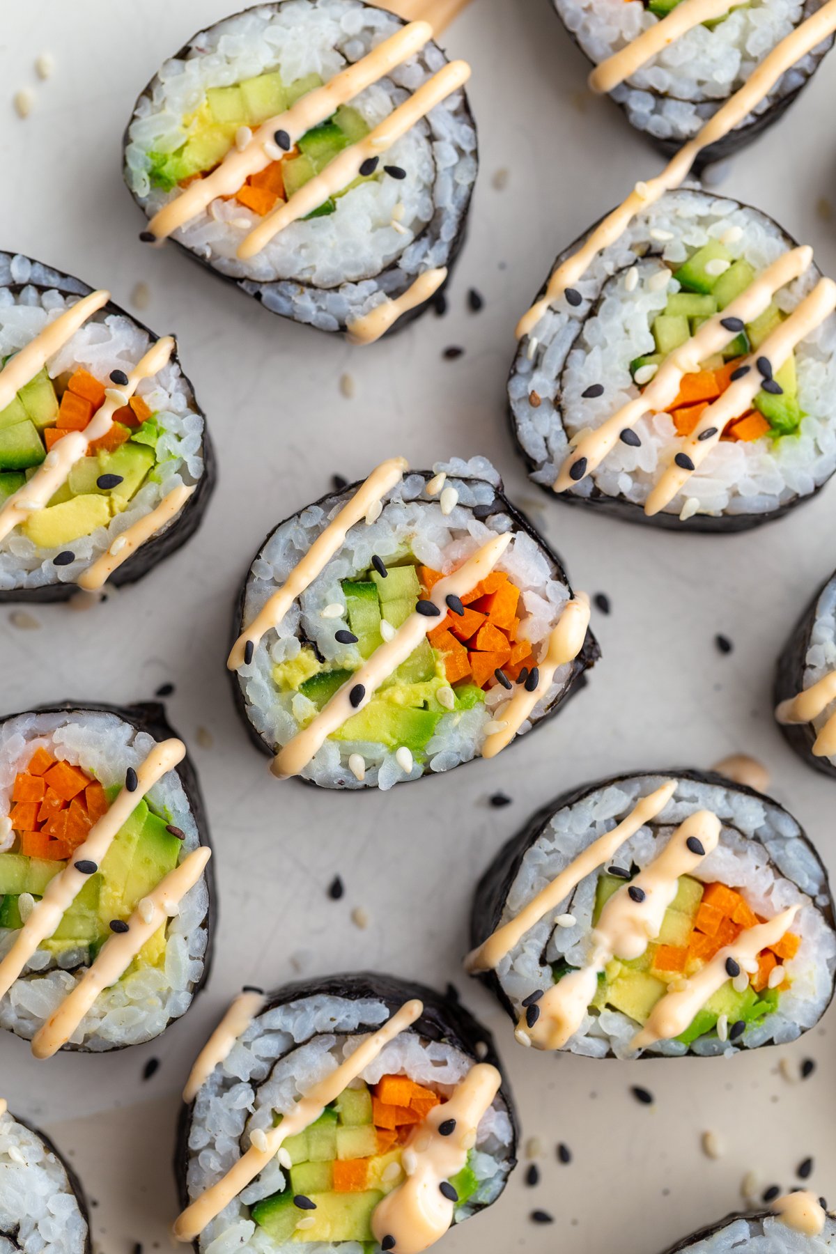 Cucumber rolls drizzled with spicy mayo.