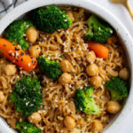 up close shot of ramen noodles with veggies and sprinkled with sesame seeds