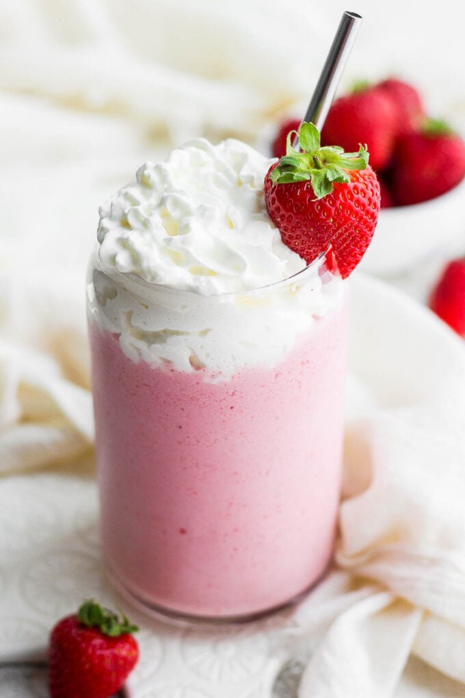 Strawberry shake topped with whipped cream.