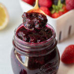 spooning out mixed berry compote