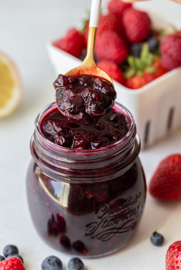 spooning out mixed berry compote