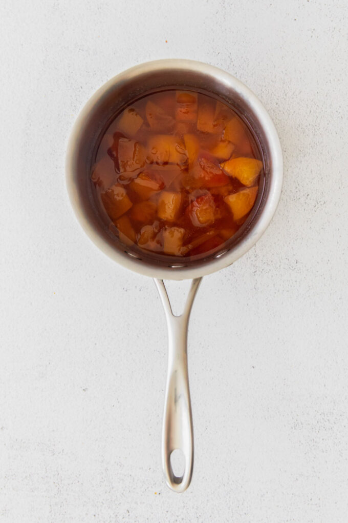 making peach simple syrup in a small pot