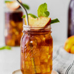 peach iced tea served in a mason jar with a peach slice