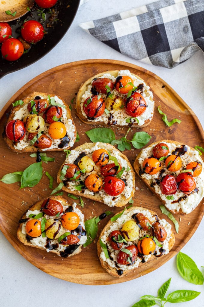 toast topped with ricotta, blistered tomatoes and basil