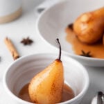 vanilla poached pear in a small white bowl