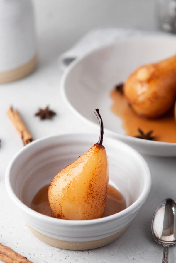 vanilla poached pear in a small white bowl