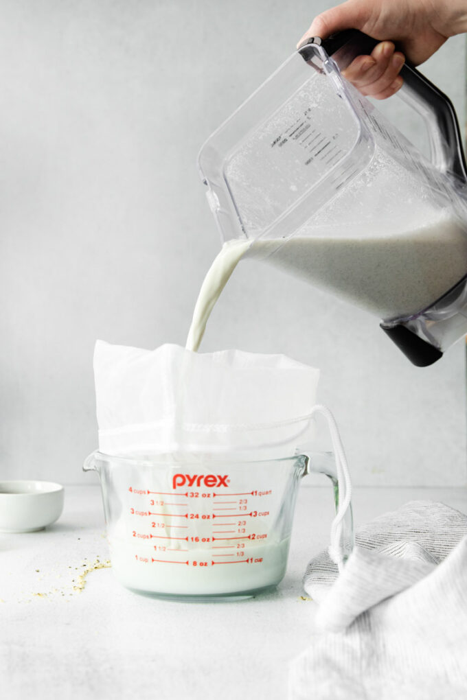 pouring milk into a nut milk bag