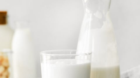 macadamia nut milk in a milk jug and small glass