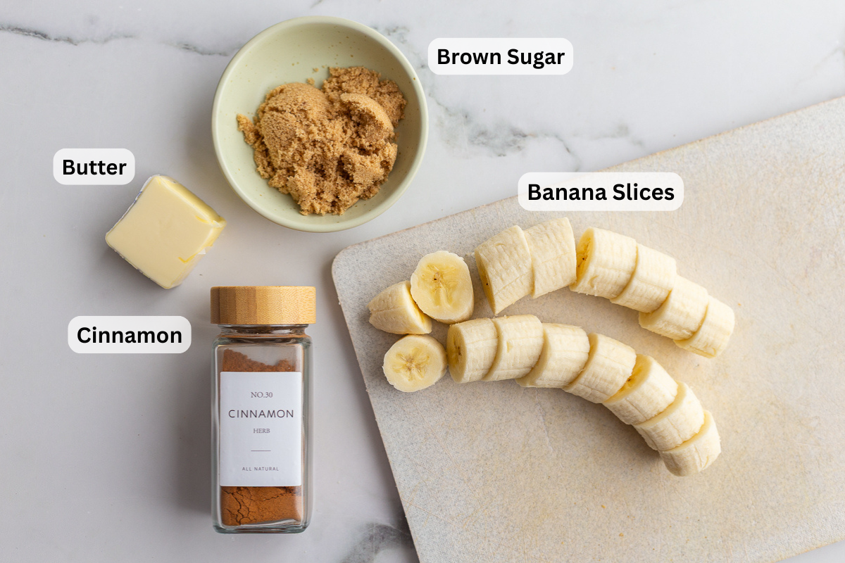 labeled ingredients needed to make caramelized bananas including banana slices, cinnamon, brown sugar, and butter