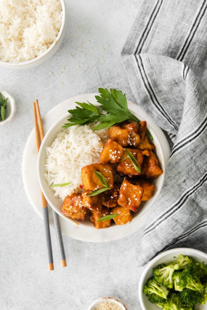 spicy tofu served with chopsticks in a small white bowl with white rice