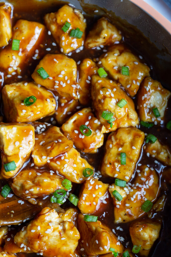 tofu cooked in a sticky sauce in a skillet