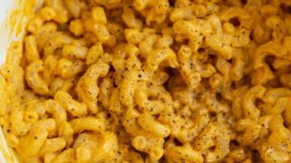 Mac and cheese in a pot with a wooden spoon