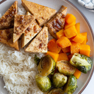 tofu and veggies over rice in a bowl