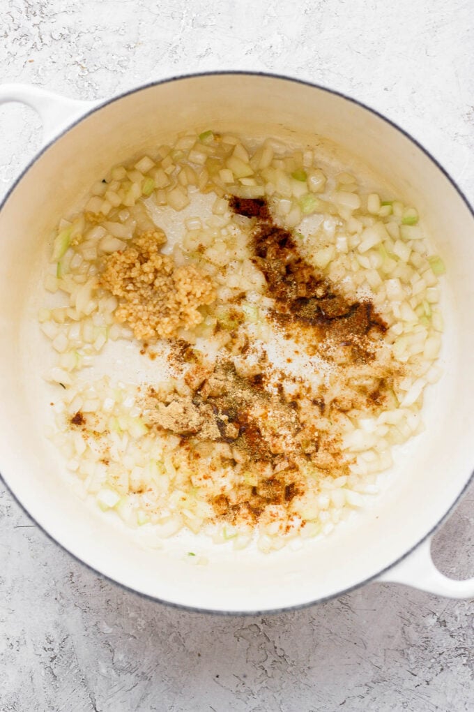 Sautéing onion and spices in a large pot.