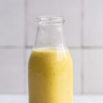 creamy garlic dressing in a small glass jar