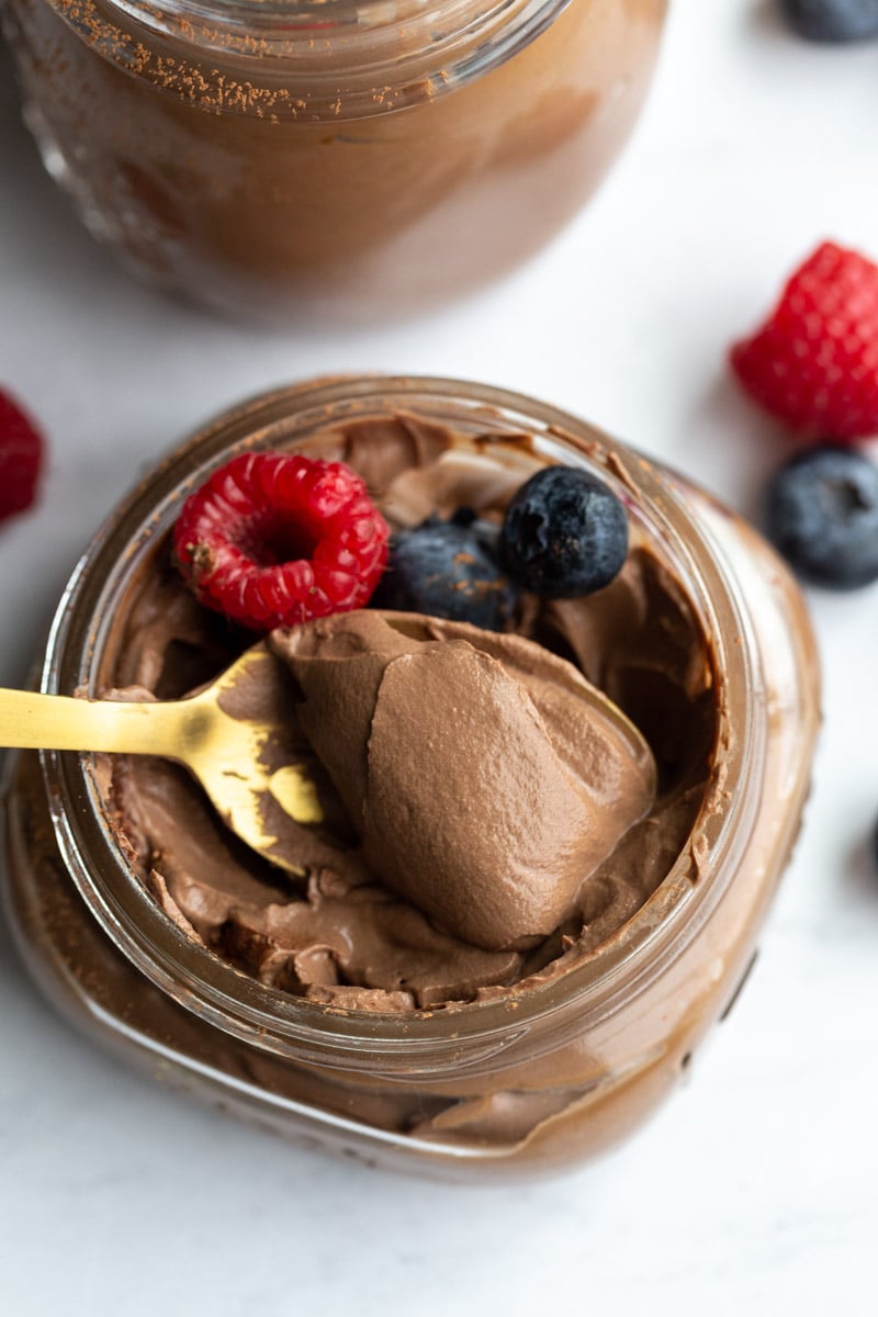 spooning out a bite of vegan chocolate mousse