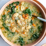 white bean and kale soup in a bowl with a spoon