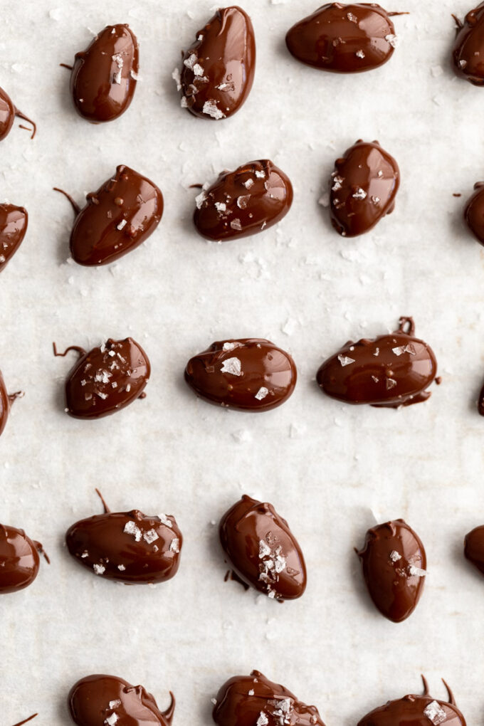 chocolate covered almonds on parchment paper