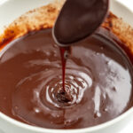 Vegan Chocolate Ganache dripping from a spoon
