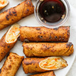 Vegan Egg Rolls on a white plate with sauce