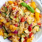 Orzo pasta salad with roasted veggies mixed in.