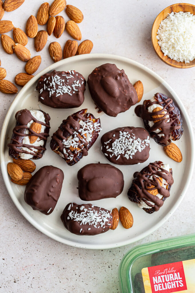 medjool dates stuffed with coconut and topped with an almond and meted chocolate