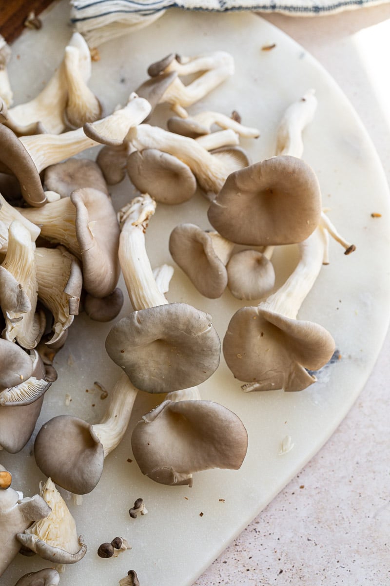 Oyster mushrooms on a marble tray.