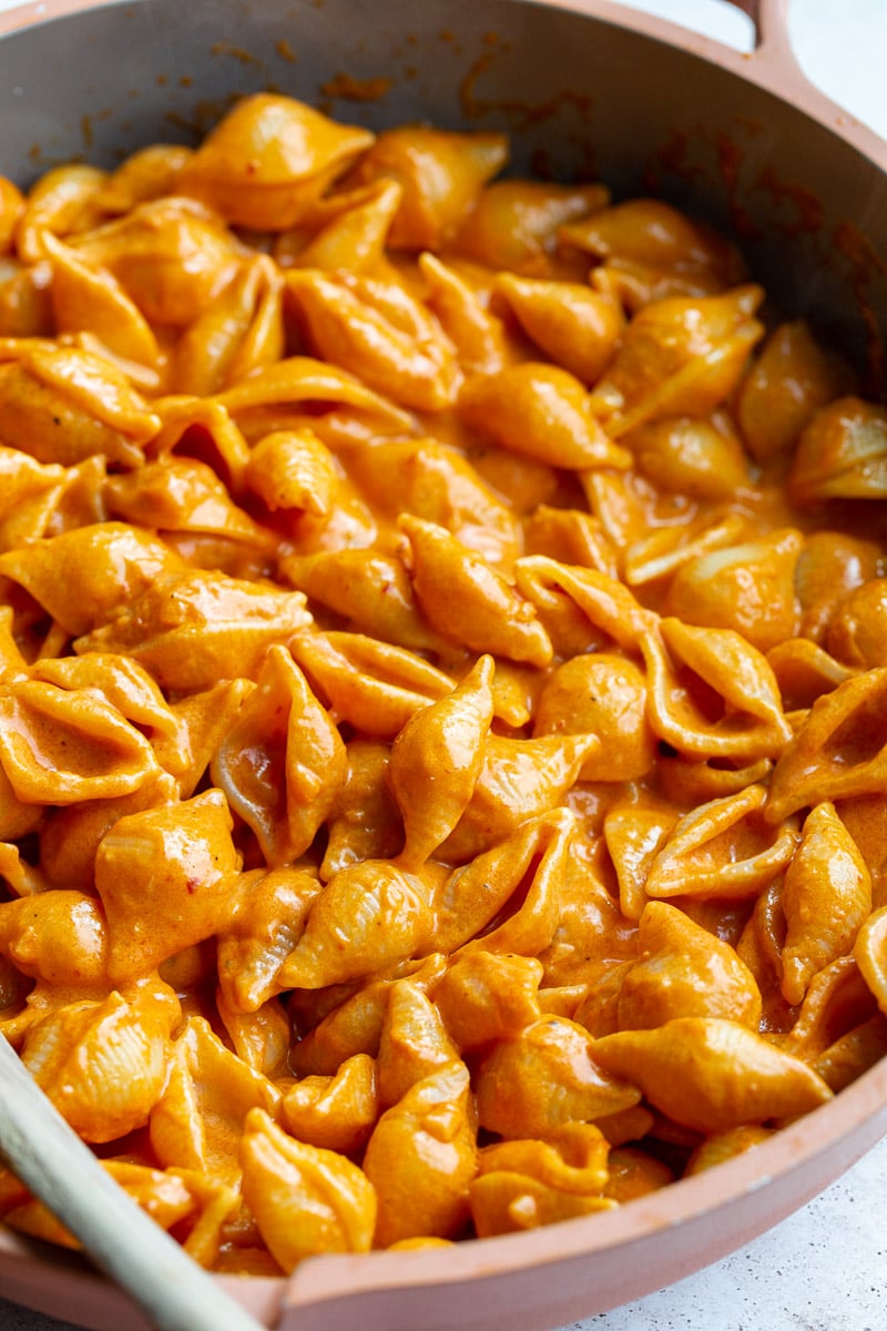 Creamy pasta shells in a skillet.