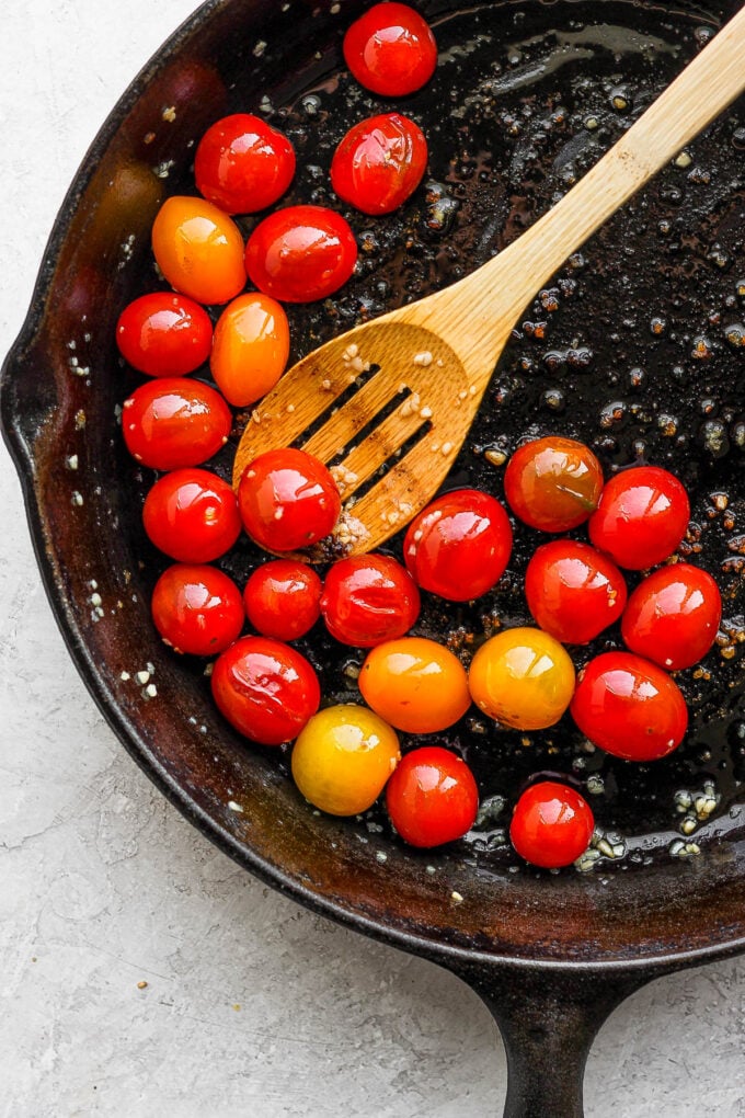 Cooking tomatoes in a skillet.