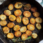 rosemary fried potato coins in a skillet
