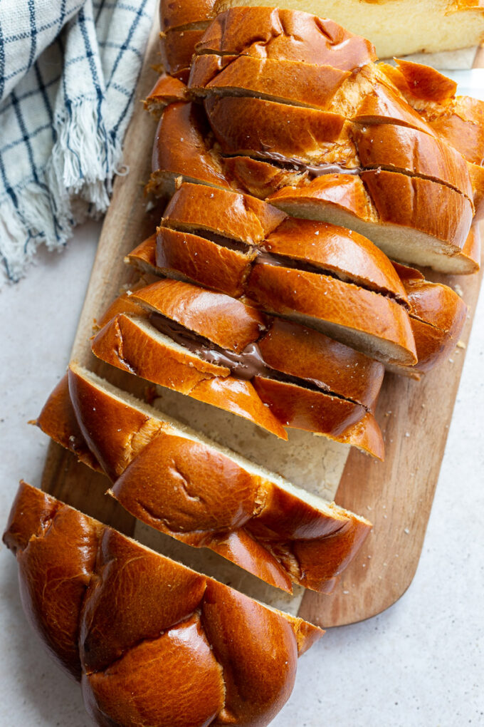 Challah bread sliced on a cutting board.