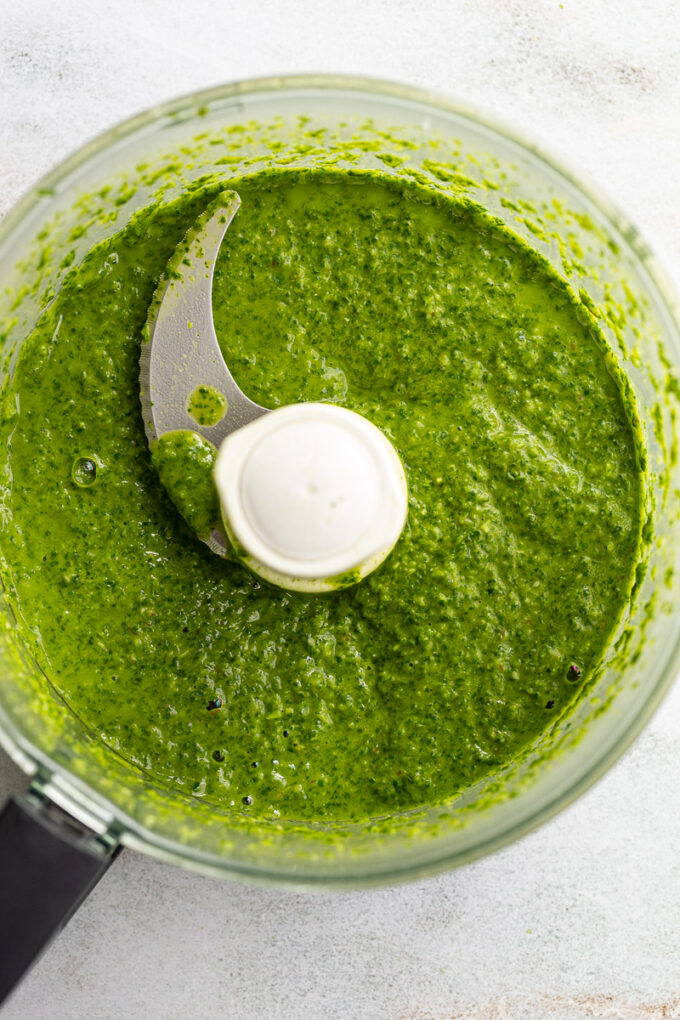 Using a food processor to make a green sauce.