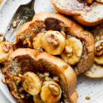 Bananas Foster French Toast served on a white plate.