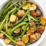 Roasted Potatoes and Green Beans in a white serving bowl.
