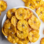 Plantain chips served in a small white bowl.