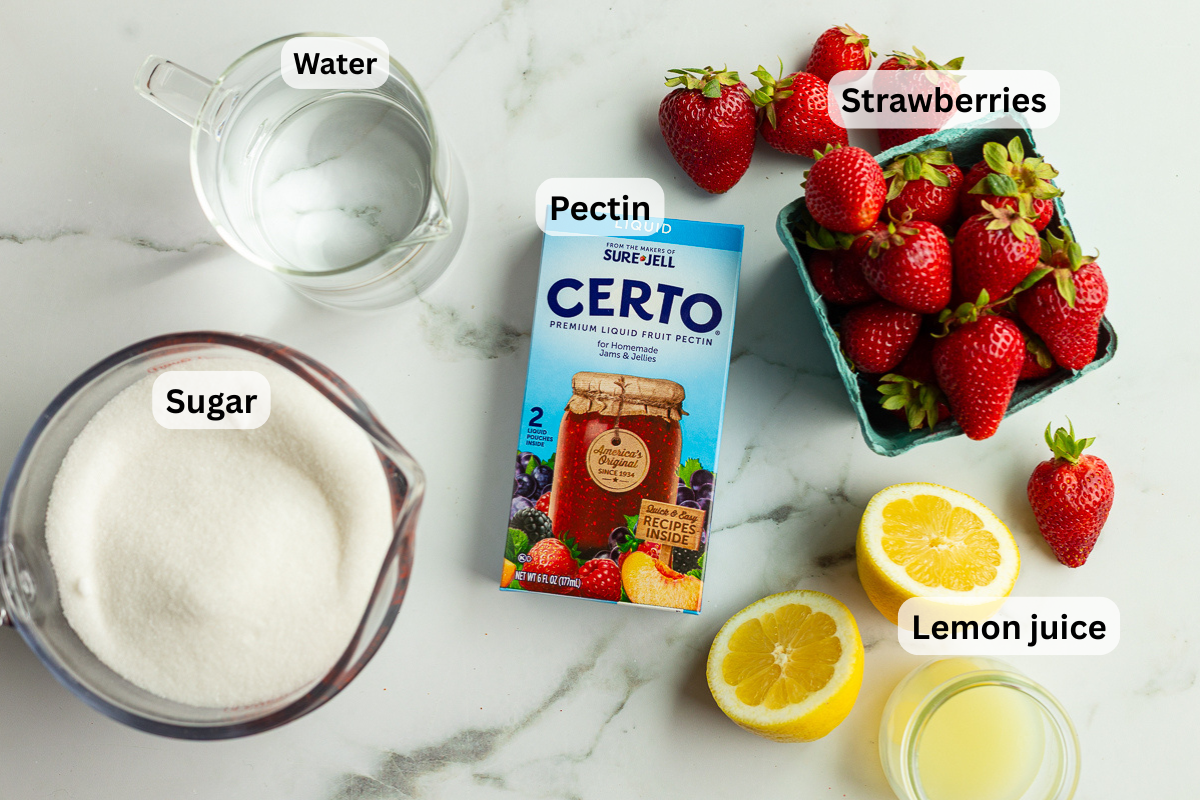 Labeled ingredients for strawberry freezer jam including strawberries, sugar, liquid pectin, water, and lemon juice