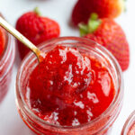 Spooning out strawberry jam.