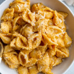 creamy pumpkin macaroni pasta with shredded parmesan on top
