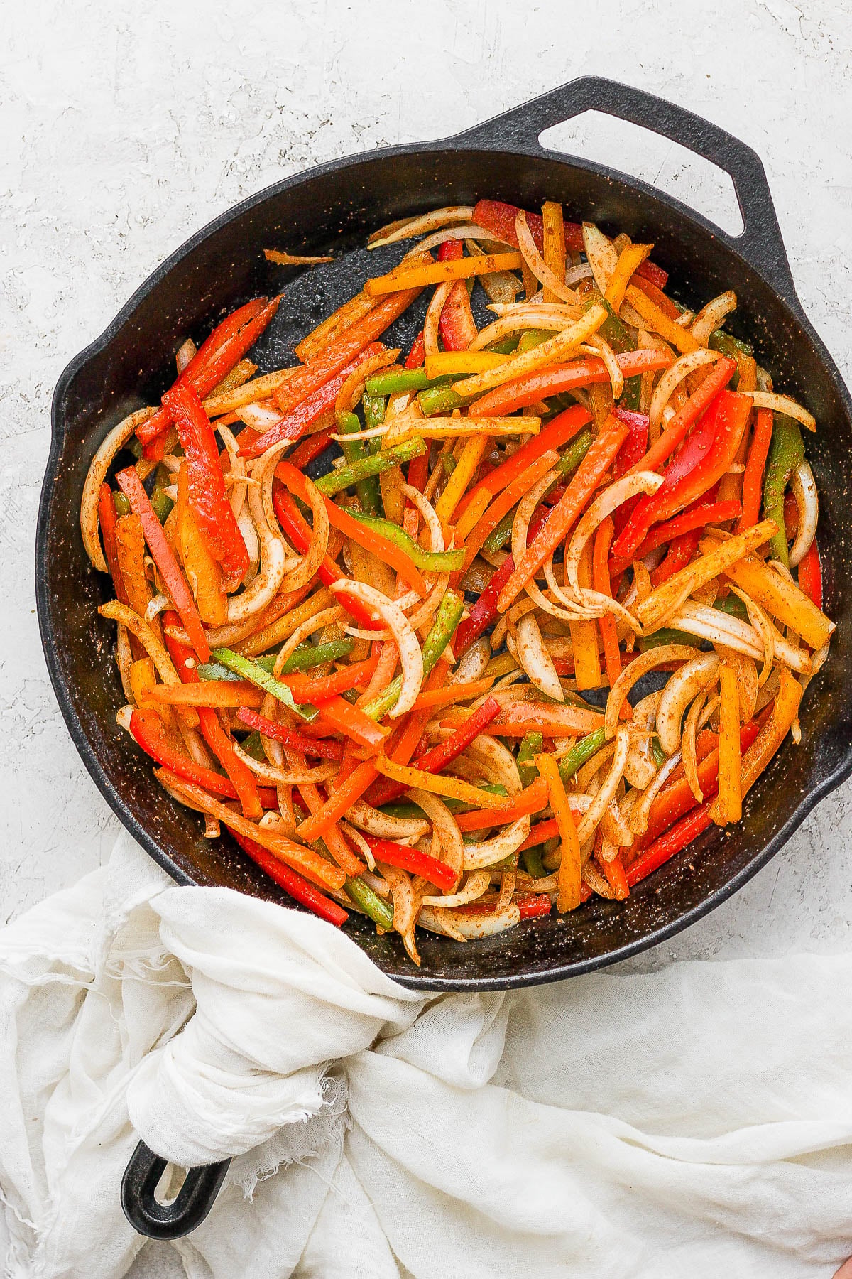 Sautéing fajita veggies in a hot skillet.