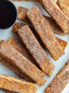 French toast sticks served with maple syrup.