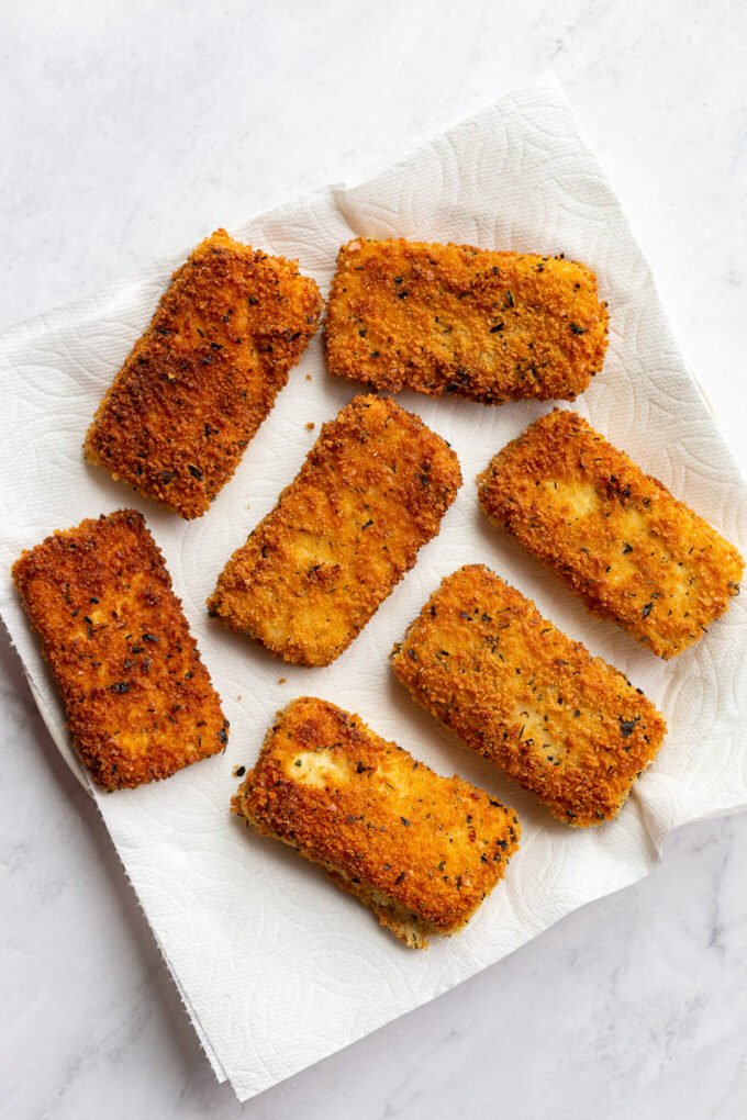 Breaded and fried tofu pieces on paper towels.