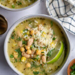 White Chickpea Chili topped with cheese and a lime wedge.