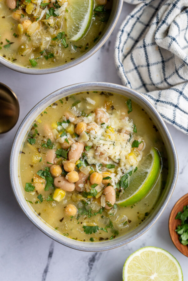 White Chickpea Chili topped with cheese and a lime wedge.