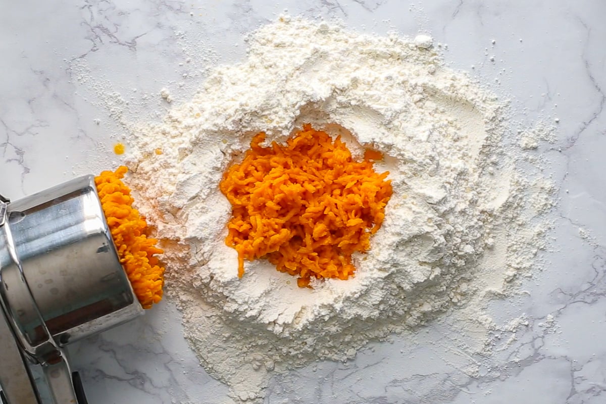 sweet potato riced in a pile of flour