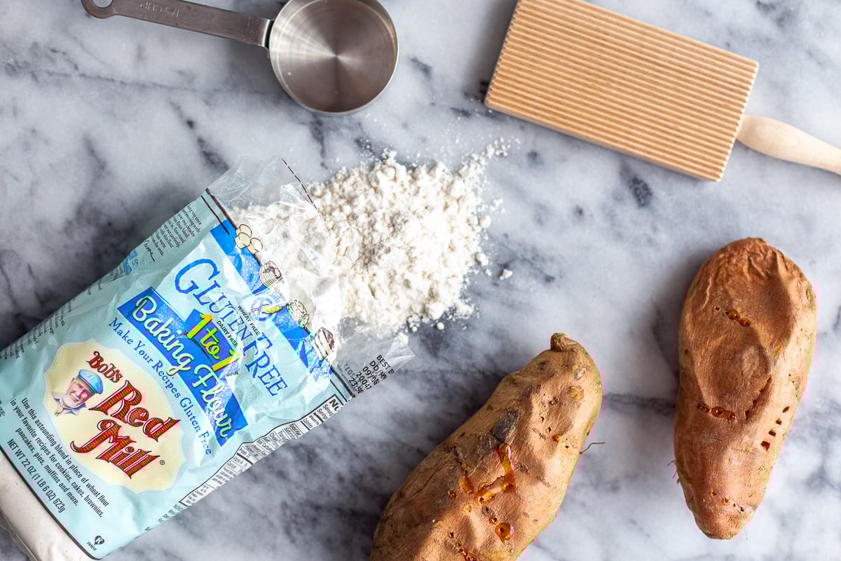 ingredients needed to make sweet potato gnocchi including flour, and cooked sweet potatoes