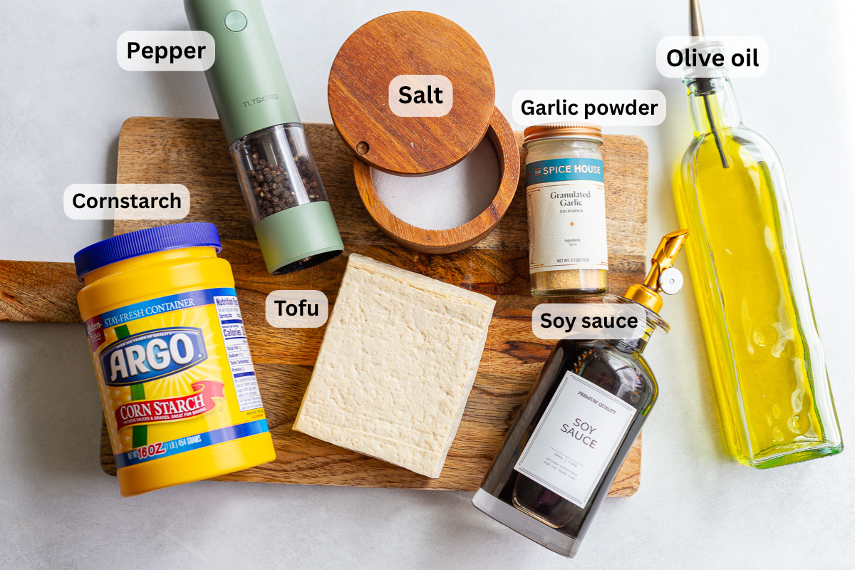ingredients needed to fry tofu including tofu, oil, cornstarch, garlic powder, salt, and pepper