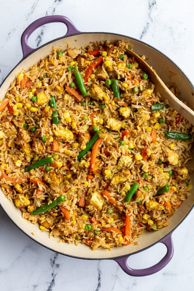 tofu fried rice with veggies in large purple skillet