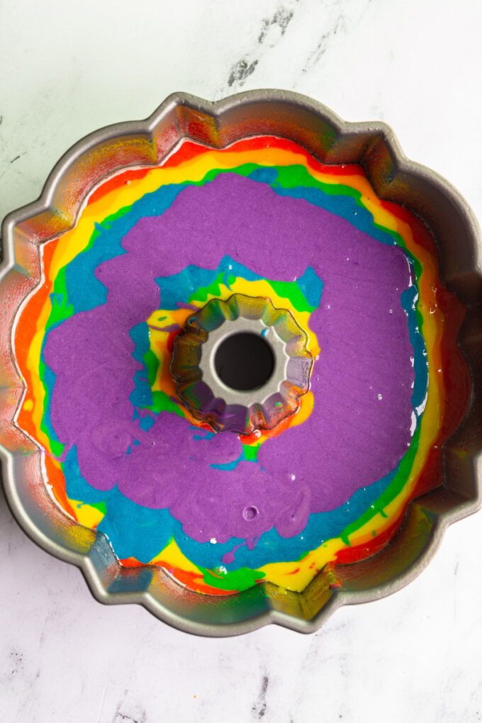 rainbow tidye bundt cake batter in the pan