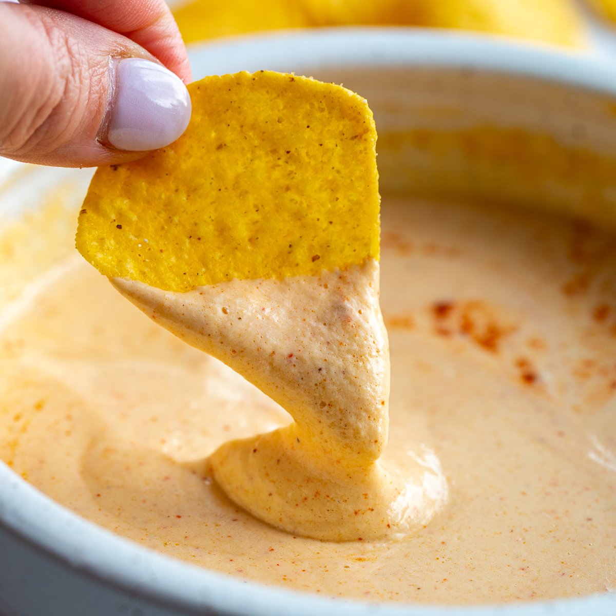 cottage cheese queso on a tortilla chip